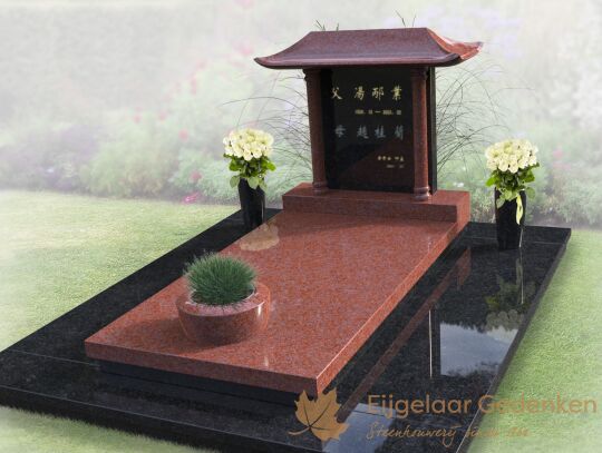 Chinees grafmonument met bloemen en plantenbak