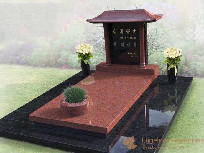 Chinees grafmonument met bloemen en plantenbak foto 1