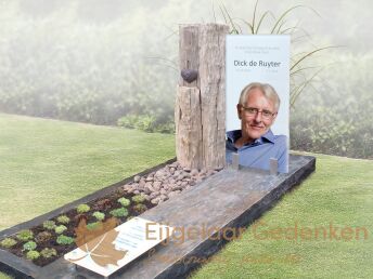 Modern glazen grafmonument met ruwe steensoorten